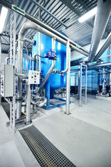 Large blue tanks in a industrial city water treatment boiler room. Wide angle perspective. Special...