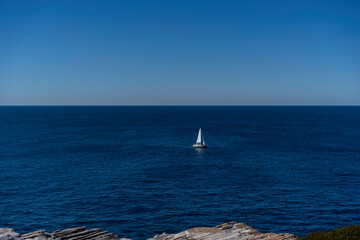 Obraz premium Seascape of the beautiful blue ocean/ sea with a Yacht Sailing in the sea