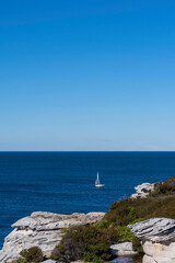 View of yacht with white sails in the Sea on a beautiful sunny day