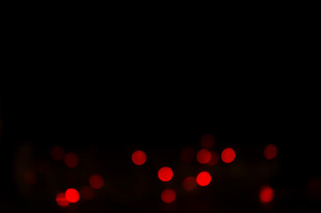 Abstract red lights bokeh on dark background.