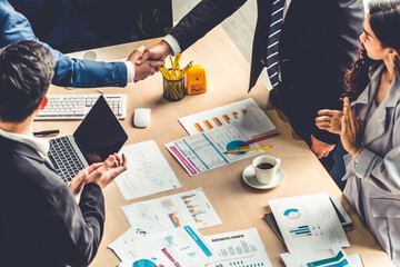 Group business people handshake at meeting table in office together with confident shot from top...