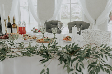 beautifully laid tables with glasses and appliances at morning in restaurant