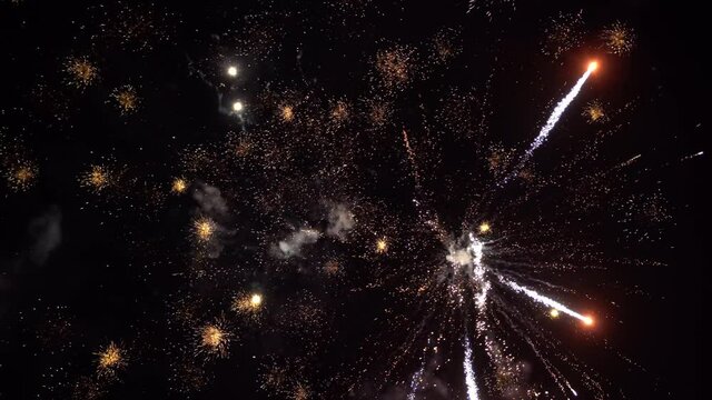volleys of fireworks in night sky.
