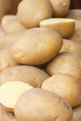 Fototapeta na wymiar Fresh ripe potatoes in box on stall at bazaar