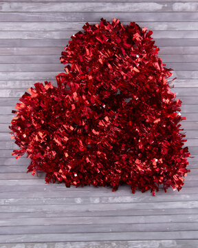 Glittery Red Tinsel Heart On Gray Wooden Background