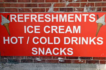 A sign at the seaside for refreshments, ice cream, drinks and snacks at Weymouth in Dorset, England.
