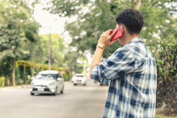 Asian man waiting for Uber taxi