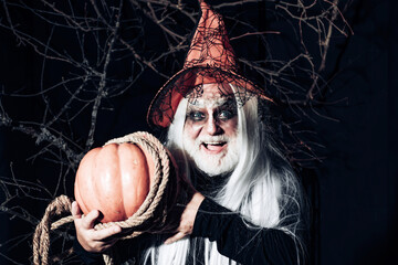 Halloween concept. Scary Halloween man in hat - studio shot close-up. Portrait of Devil with...