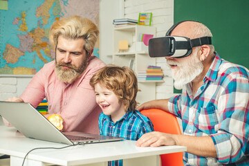 Obraz premium Three generations of men having fun together. GrandFather, father and son playing computer games at home. Parenting childhood values weekend.