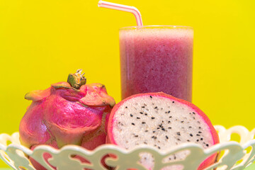 Pitaya juice and fresh fruits on yellow background
