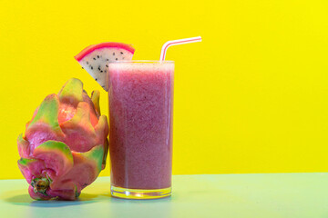 Pitaya juice and fresh fruits on yellow background