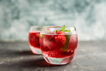 Raspberry and mint cocktail in glass on the rustic background. Selective focus. Shallow depth of field.