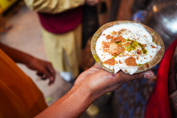 Detail of Indian snack held by hand in Agra downtown
