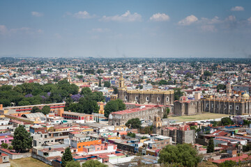 Fototapeta na wymiar View of rooftops of Puebla City, Mexico with blue sky