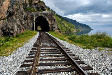 Circum-Baikal old railway with tunnel on summer cloudy day