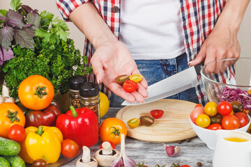 Woman cooks at the kitchen, soft focus background