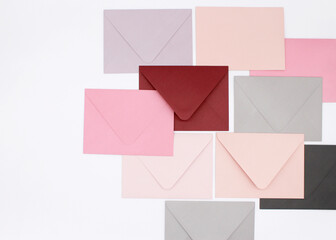 Pink-tone paper envelopes on a white background	
