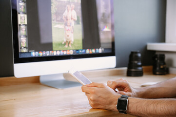 Fototapeta premium Professional Photographer Works in Photo Editing App. Photographer uses tablet