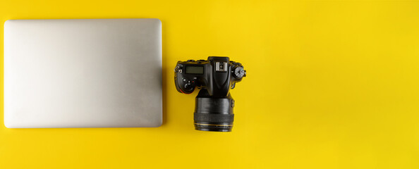 Photographer's equipment.Flat lay composition with photographer's equipment and laptop on yellow...