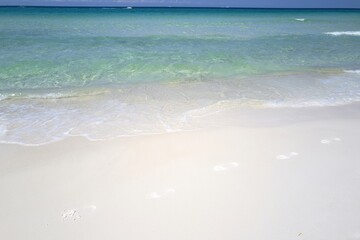 Travel summer holiday background concept. Sand beach with blue ocean and cloudscape background. Tropical vacation paradise with white sandy beaches.