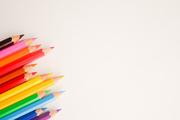 Fototapeta premium The cropped shot view of color pencils with white background, blank copy space screen for your text message or information content.