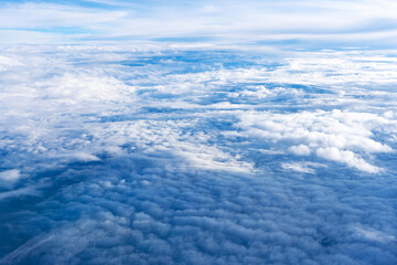 Fluffy clouds top view of the airplane. Heavenly landscape