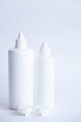 Contact lenses lens care products in white bottles on white background lens containers