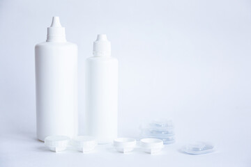 Contact lenses lens care products in white bottles on white background lens containers