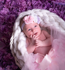 Cute newborn girl with a bandage on her head.