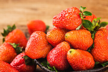 Bunch of fresh strawberries on wooden board background
