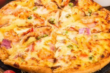 Tasty fresh pizza with seafood on table,