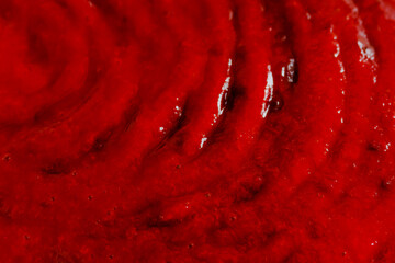 the red liquid, syrup making an abstract background