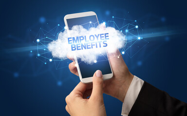 Female hand touching smartphone with EMPLOYEE BENEFITS inscription, cloud business concept