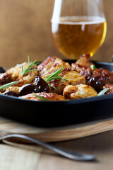 Grilled chicken pieces with kalamata olives and fresh rosemary. Close up.	