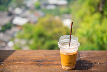 The plastic coffee glass with forest background