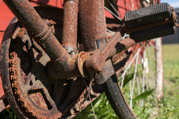 Details on an old rusty bicycle with pedal arm and chain