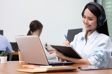 Asian business woman and women talk and note job on paper in office.