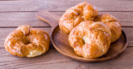 Freshly croissant on wooden background. It is a type of French pastry suitable as breakfast. It can be purchased at bakery worldwide.