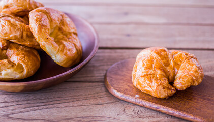 Freshly croissant on wooden background. It is a type of French pastry suitable as breakfast. It can be purchased at bakery worldwide.