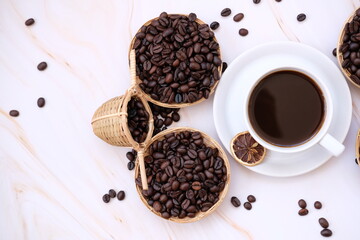 coffee cup and coffee beans on old wood table background