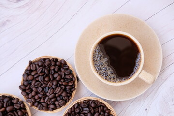 coffee cup and coffee beans on old wood table background