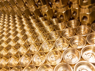 shiny brass metal threaded hexagonal fitting parts, abstract perspective industrial close-up...