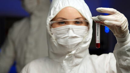 Naklejka premium Scientist testing sample for Coronavirus in tube