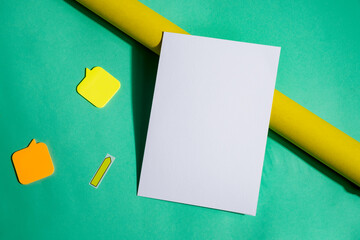 Mock-up brochure and roll of yellow paper.