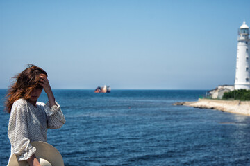 Young attractive girl is resting at the sea.