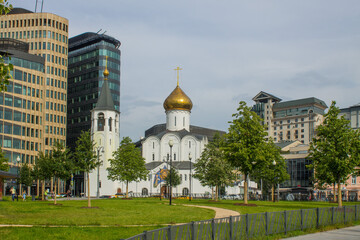 Church of St. Nicholas at Tverskaya Zastava and modern business center on a cloudy summer day and space for copying in Moscow Russia