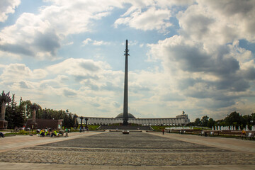 Fototapeta na wymiar high spire-Victory Monument on Poklonnaya hill on a cloudy summer day and space for copying in Moscow Russia