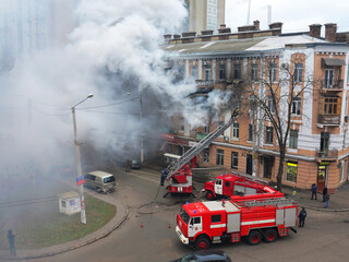 Odessa, Ukraine - December 29, 2016: A fire in apartment building. Strong bright light and clubs, smoke clouds window of their burning house. Firefighters extinguish fire in house. Work on fire stairs