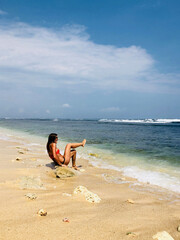 Young woman enjoying summertime in the ocean / sea water.