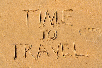 Time to Travel written on the beach